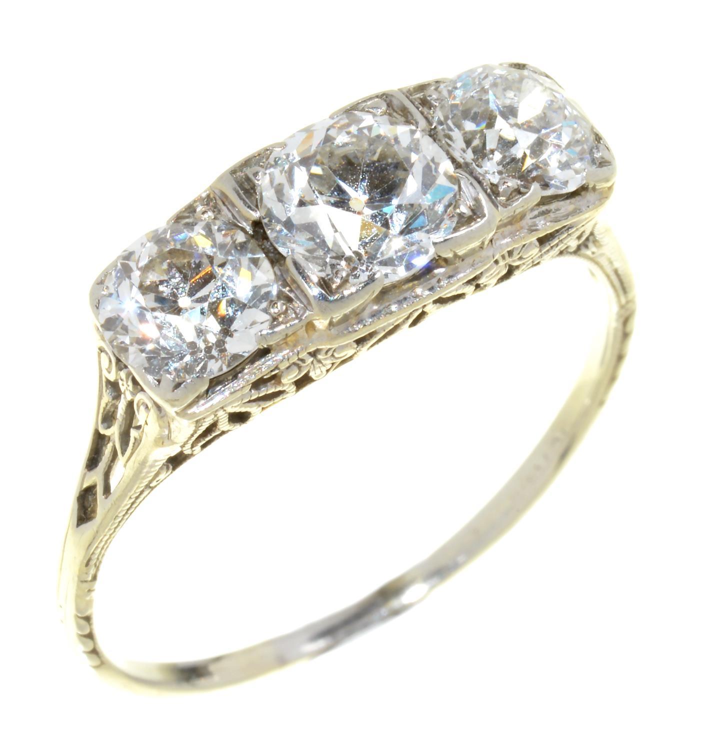 A THREE STONE DIAMOND RING the old cut diamonds 1.57ct approx, in white gold, 2g, size P½ Good