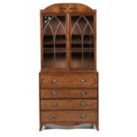 A GEORGE IV MAHOGANY SECRETAIRE BOOKCASE, C1830 with dart inlaid and figured low arched cornice,