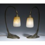 A PAIR OF FRENCH PATINATED BRASS TABLE LAMPS AND DAUM GLASS LAMPSHADES, C1930  41cm h, etched mark