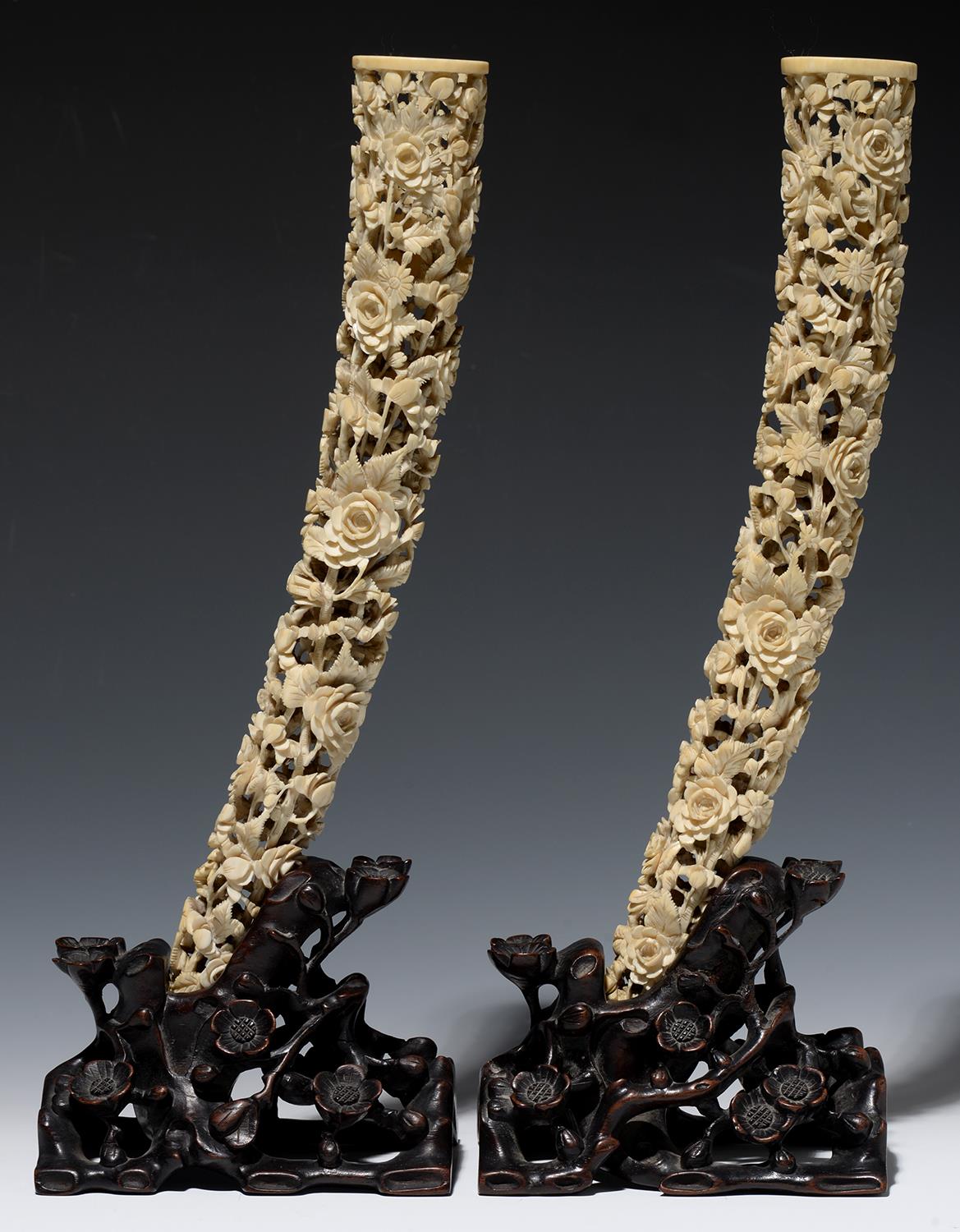 A PAIR OF CHINESE PIERCED IVORY TUSK CARVINGS ON CONTEMPORARY OPENWORK HARDWOOD STANDS, CARVED AS - Image 2 of 2