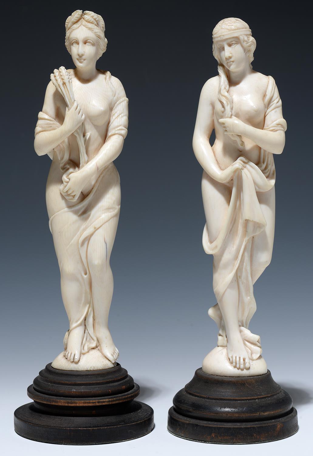 TWO EUROPEAN IVORY STATUETTES OF VENUS AND CERES, ON AFFIXED, TURNED AND STAINED EBONISED BASE, 24