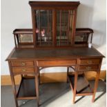 AN EDWARDIAN MAHOGANY WRITING TABLE WITH TOOLED LEATHER TOP, BEARING BRASS TRADE LABEL FOR W. HOMANN