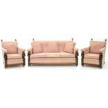 A CARVED OAK THREE PIECE LOUNGE SUITE, UPHOLSTERED IN PINK FABRIC, SOFA 175CM W, SECOND QUARTER 20TH