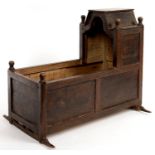 MINIATURE FURNITURE.  AN 18TH C STYLE PANELLED OAK CRADLE WITH TURNED FINIALS, 38CM H