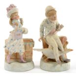 A PAIR OF GERMAN BISQUE SPILL HOLDER FIGURES OF BOY AND GIRL ICE SKATERS, 23CM H, IMPRESSED NUMBERS,