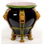 A MINTONS MAJOLICA JARDINIERE WITH STRAPWORK AND LION MASKS, ON SIX PAW FEEt, 44CM H, IMPRESSED