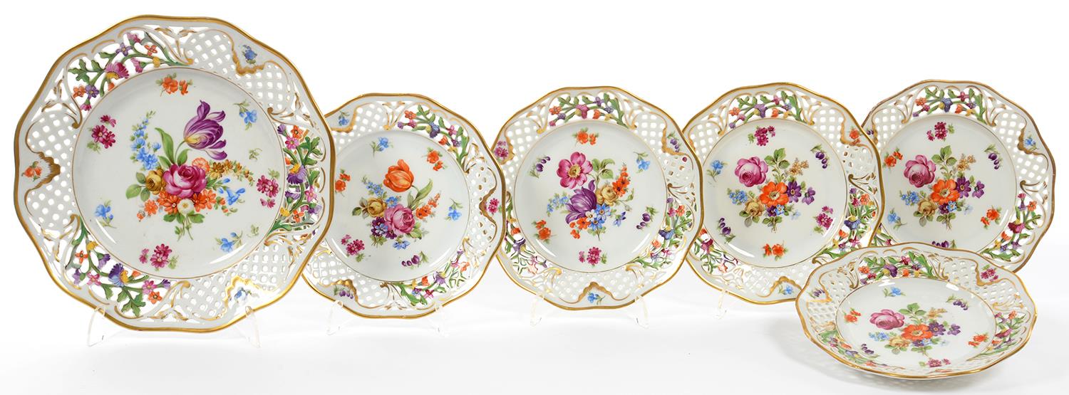 A SET OF SIX GERMAN RETICULATED PLATES, PAINTED WITH FLOWERS, ONE 26CM DIAM, THE OTHERS 19CM,