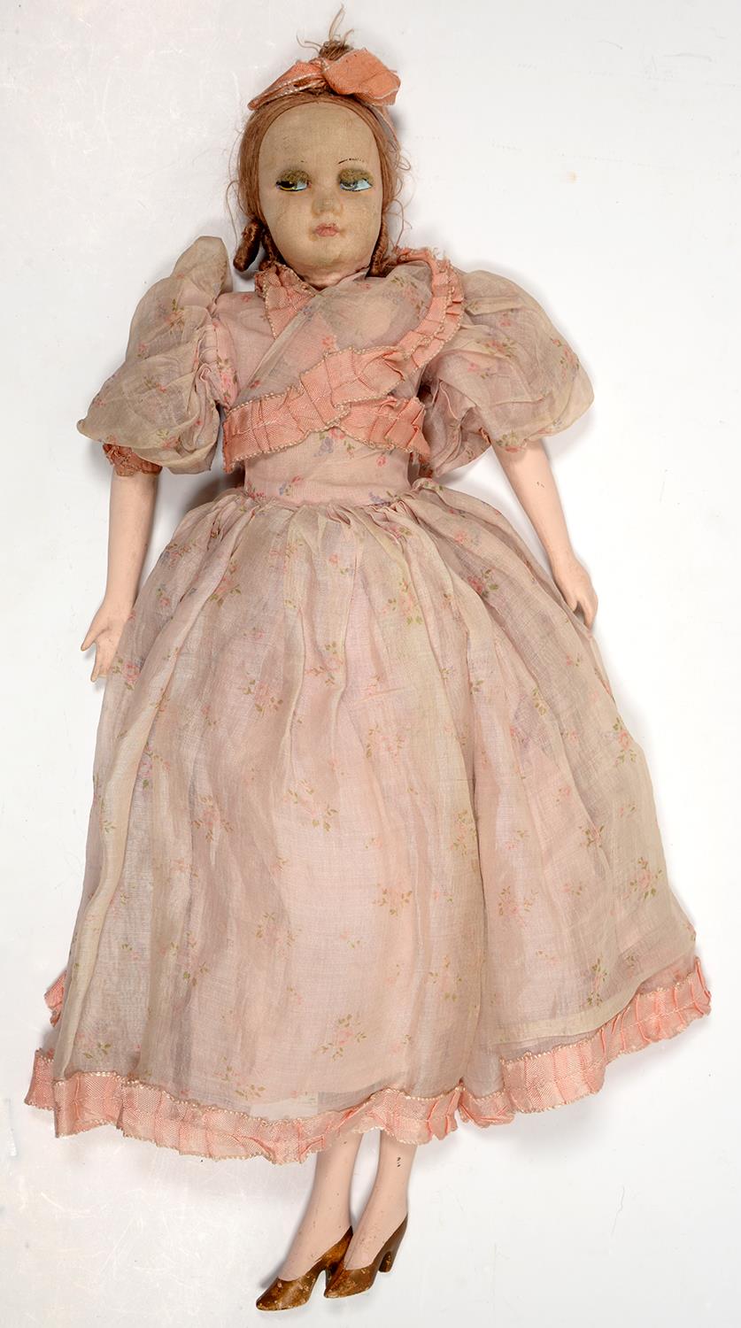 A 1930'S PADDED CLOTH BOUDOIR DOLL WITH PAINTED WOOD FORELIMBS