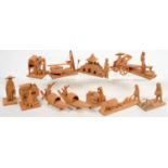 A COLLECTION OF SOUTH EAST ASIAN MINIATURE WOOD CARVINGS OF FIGURES AT VARIOUS PURSUITS, A BRIDGE OR