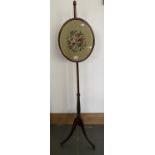 A REGENCY MAHOGANY POLE SCREEN WITH WOOLWORK BANNER, A BRASS FENDER AND PAINTED WOODEN BUCKET,