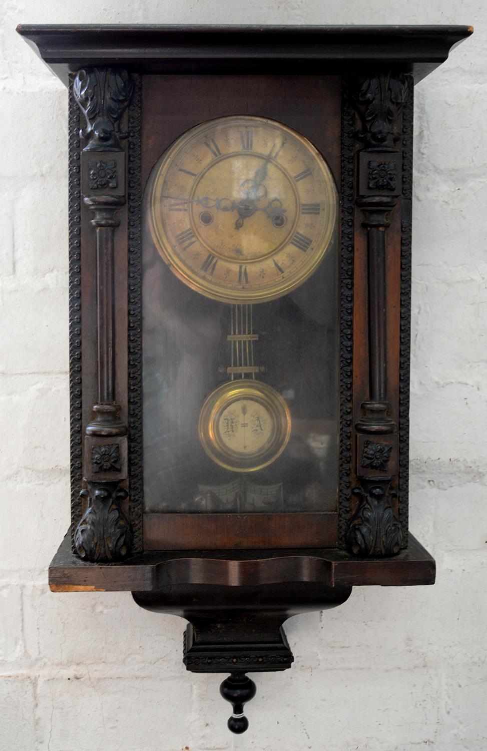 A GERMAN CARVED AND STAINED WALL CLOCK WITH GRIDIRON PENDULUM, 55CM H, C1900