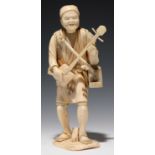 A JAPANESE SECTIONAL IVORY OKIMONO OF A MAN PLAYING THE SAMISEN, 20CM H, SIGNED, MEIJI PERIOD