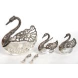 A SET OF THREE SILVER MOUNTED GLASS SWAN SALT CELLARS AND TWO SPOONS, LARGEST 12 CM H, IMPORT MARKED