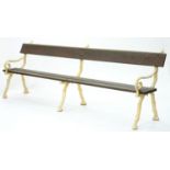A VICTORIAN  GARDEN BENCH WITH RUSTIC CAST IRON ENDS AND TIMBER SLATS, 260CM W
