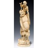 A JAPANESE IVORY OKIMONO OF HOTEI AND A BOY, 25.5CM H, SIGNED, MEIJI PERIOD