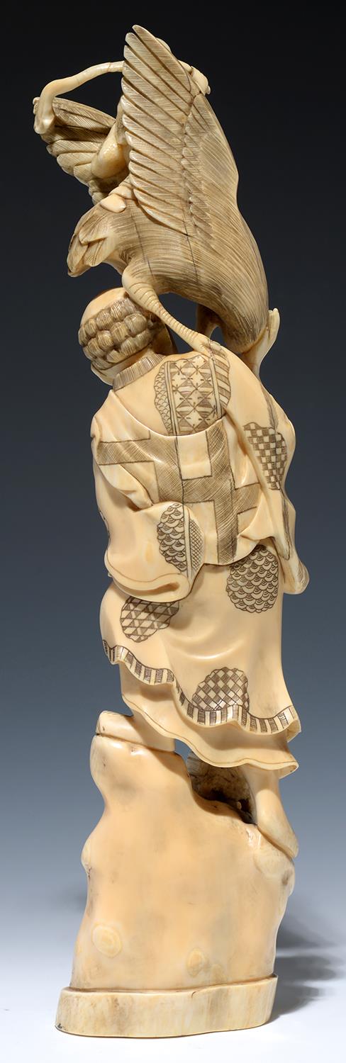 A JAPANESE IVORY OKIMONO OF A MAN HOLDING A PEACH AND VISITED BY  JUROJIN CARRIED ON A  A STORK ON - Image 2 of 2