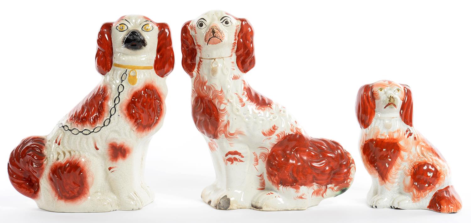 THREE STAFFORDSHIRE EARTHENWARE MODELS OF SPANIELS, WITH SPONGED RUST FEATHERY MARKS, 28CM H, 19TH C
