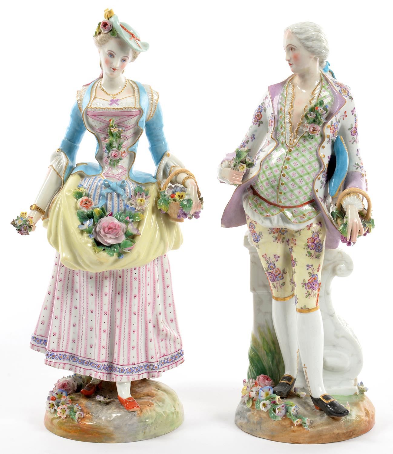 A PAIR OF FRENCH PORCELAIN FIGURES OF A LADY AND GALLANT AS FLOWER GATHERERS, ON FLORAL ENCRUSTED