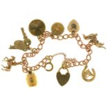 A 9CT GOLD CHARM BRACELET, 18G ONE CHARM UNMARKED. LIGHT SURFACE WEAR CONSISTENT WITH AGE AND USE