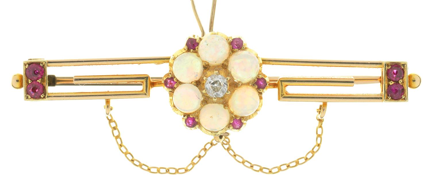 AN OPAL, DIAMOND AND RUBY BAR BROOCH IN GOLD, 50 MM W, UNMARKED, 5.8G NO DAMAGE TO STONE. LIGHT