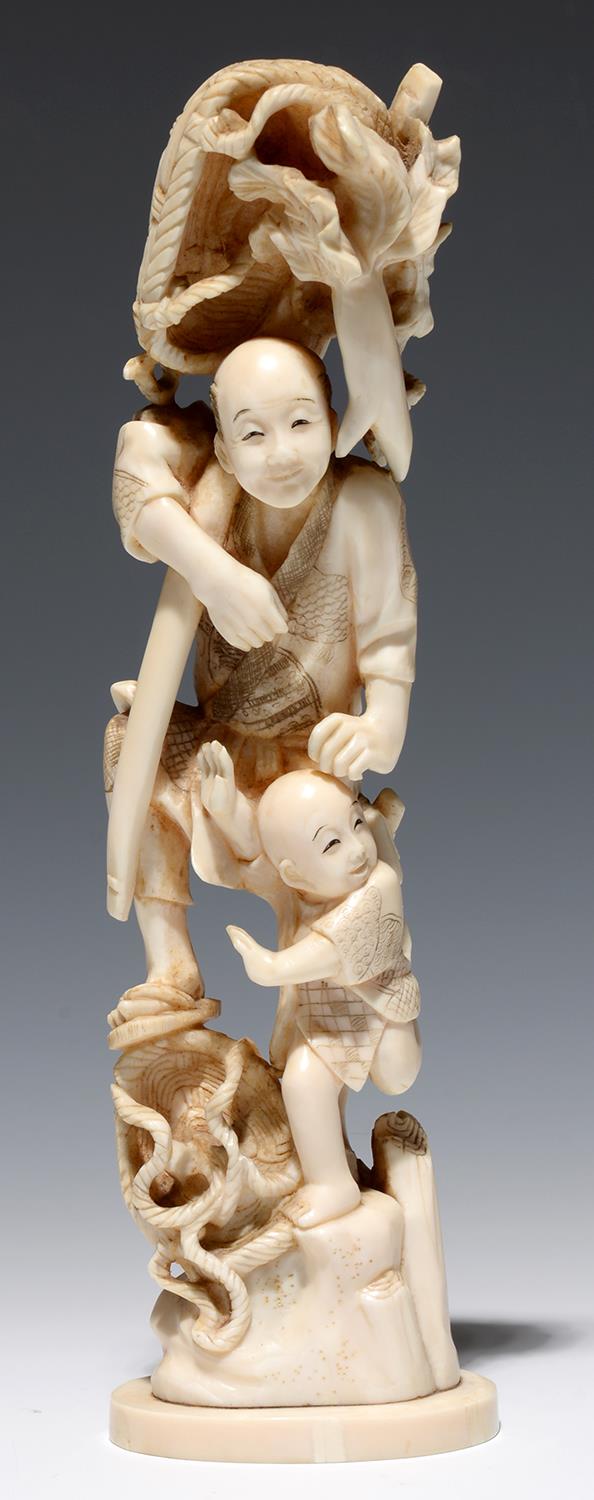 A JAPANESE IVORY OKIMONO OF A FISHERMAN AND HIS YOUNG SON, 23CM H, SIGNED, MEIJI PERIOD