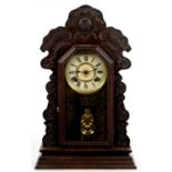AN ANSONIA CARVED AND STAINED SOFTWOOD SHELF CLOCK WITH GILT GLASS DIAL, GONG STRIKING MOVEMENT