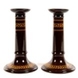 A PAIR OF WEDGWOOD BROWN GLAZED EARTHENWARE CANDLESTICKS WITH ACORN AND OAK LEAF OCHRE BANDED