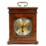 A WALNUT AND FEATHER BANDED TABLE WITH CLOCK IN LATE 17TH C ENGLISH STYLE, BRASS DIAL AND ROD GONG