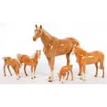 FOUR BESWICK PALOMINO HORSES AND A FOAL, 30CM H AND SMALLER, PRINTED MARK
