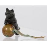 SEWING TOOLS.  A BRONZED METAL AND BRASS CAT AND BAL NOVELTY TAPE MEASURE, 4CM H, LATE 19TH C