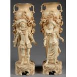 A PAIR OF AUSTRIAN OLD IVORY GROUND EARTHENWARE VASES,OF SLENDER TWO HANDED FORM ON RUSTIC BASE, SET