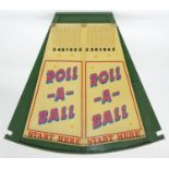ROLL-A-BALL. A SHOWMAN'S PAINTED WOOD FAIRGROUND GAME OF SEGMENT FORM, PAINTED IN CREAM AND GREEN
