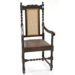 A VICTORIAN STYLE CARVED OAK ELBOW CHAIR WITH SPIRAL TURNED UPRIGHTS