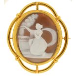 A 19TH C CAMEO BROOCH, THE OVAL SHELL CARVED WITH A CLASSICAL WOMEN AT AN ALTAR, GILTMETAL MOUNT,
