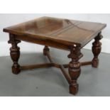 A VICTORIAN CARVED OAK DRAW LEAF DINING TABLE ON STRETCHER BASE, 77CM H; 107 X 121CM