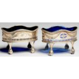 A PAIR OF GEORGE III PIERCED AND ENGRAVED OVAL SILVER SALT CELLARS, WITH BEADED RIM ON CLAW AND BALL