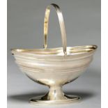 A GEORGE III SILVER SUGAR BASKET, WITH REEDED RIMS AND SWING HANDLE, ENGRAVED WITH TRAILING FOLIAGE,