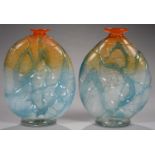 A PAIR OF COLOURED GLASS VASES OF FLATTENED FORM WITH TRAILED DECORATION AND LOW EVERTED ORANGE