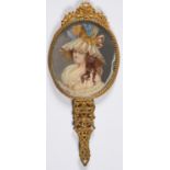 A PALAIS ROYALE GILTMETAL HAND MIRROR, THE BACK INSET WITH AN OVAL PAINTED MINIATURE OF AN 18TH C