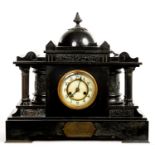 A FRENCH BELGE NOIR TEMPLE FORM MANTLE CLOCK WITH ENGRAVED BRASS TABLET 'PRESENTED TO ERNEST A