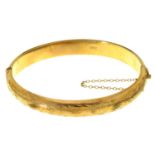 A 9CT GOLD BANGLE, FOLIATE ENGRAVED, 68MM W, BIRMINGHAM 1954, 11.5G No play in hinge, not dented