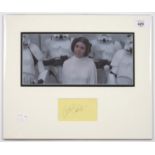 STAR WARS INTEREST. CARRIE FISHER, PIECE SIGNED, MOUNTED WITH A PHOTOGRAPH, 32 X 39CM, UNFRAMED