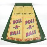 ROLL-A-BALL. A SHOWMAN'S PAINTED WOOD FAIRGROUND GAME OF SEGMENT FORM, PAINTED IN CREAM AND GREEN