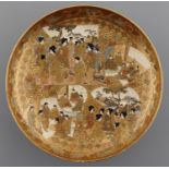 A JAPANESE SATSUMA EARTHENWARE DISH, MEIJI PERIOD, DECORATED WITH FAN SHAPED PANELS OF DIGNITARIES