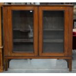 A VICTORIAN MAHOGANY BOOKCASE ON SQUARE TAPERING LEGS, ADJUSTABLE SHELVES ENCLOSED BY GLAZED
