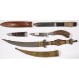 AN INDIAN BRASS AND COPPER MOUNTED DAGGER, JAMBIYA, WITH ENGRAVED DECORATION AND TWO OTHER KNIVES,