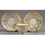 A FLIGHT, BARR AND BARR GILT TEACUP AND TWO SAUCERS WITH GADROONED RIM AND SEAWEED DECORATION,