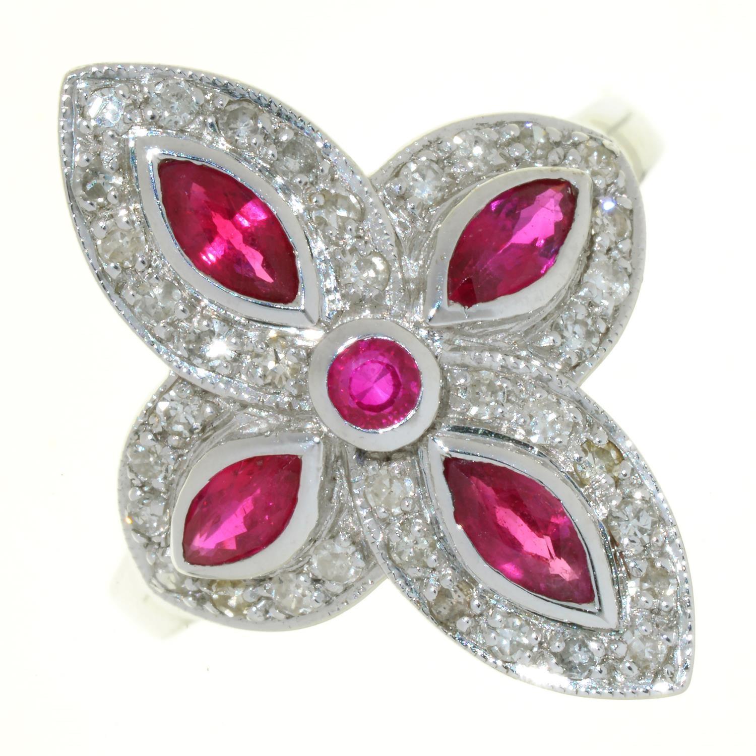 A RUBY AND DIAMOND QUADRUPLE CLUSTER RING OF CRUCIFORM DESIGN, WITH NAVETTE SHAPED RUBIES, IN 18CT