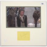 STAR WARS INTEREST. HARRISON FORD, PIECE SIGNED, MOUNTED WITH A COLOUR PHOTOGRAPH, 38 X 39CM
