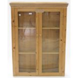 A WAXED PINE BOOKCASE, ENCLOSED BY GLAZED DOORS, EARLY 20TH C, 113CM H; 84 X 18CM